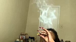 Ebony MILF masturbates with dildo and smokes